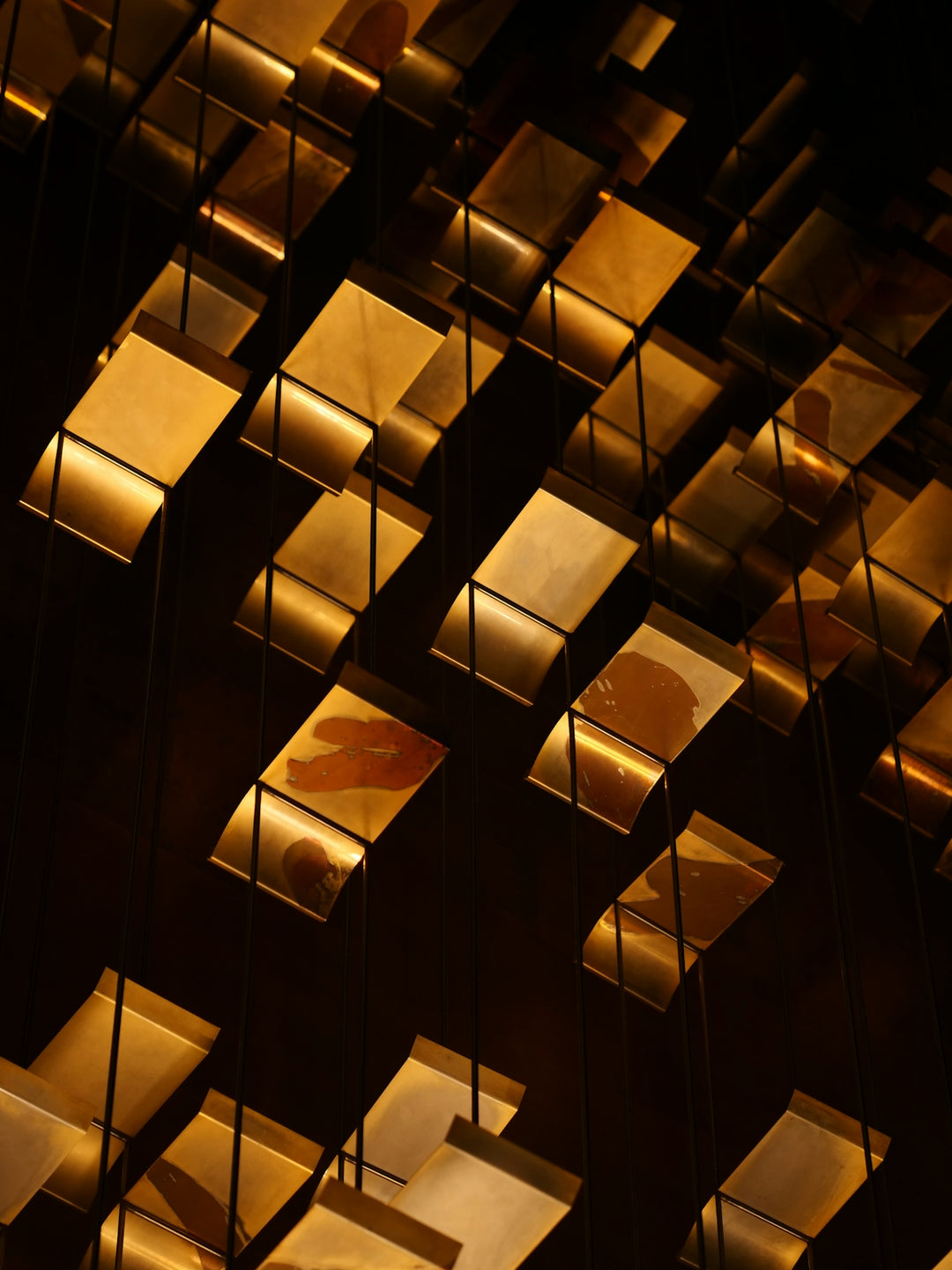 Abstract gold and dark geometric shapes with light reflections