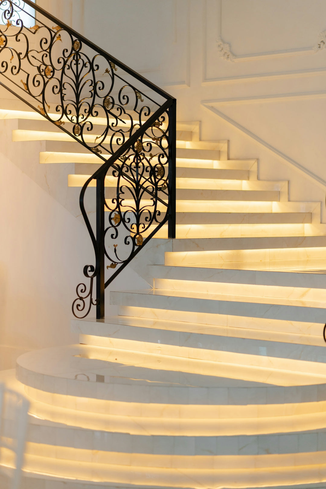Elegant white marble staircase with ornate railing