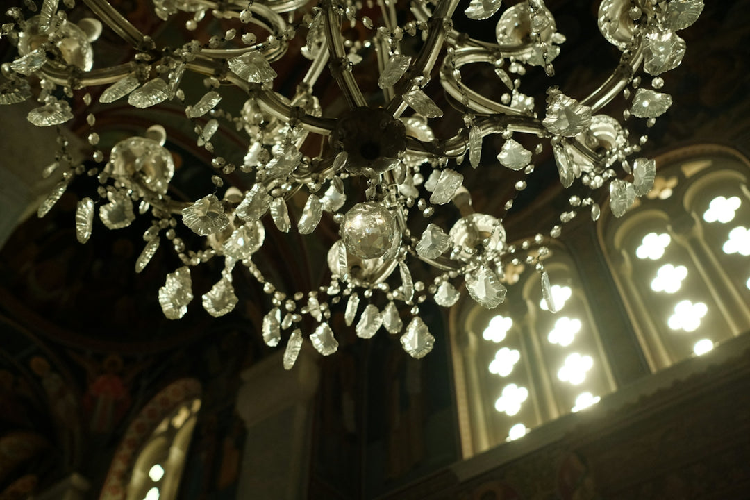 Ornate crystal chandelier hanging in a dimly lit room