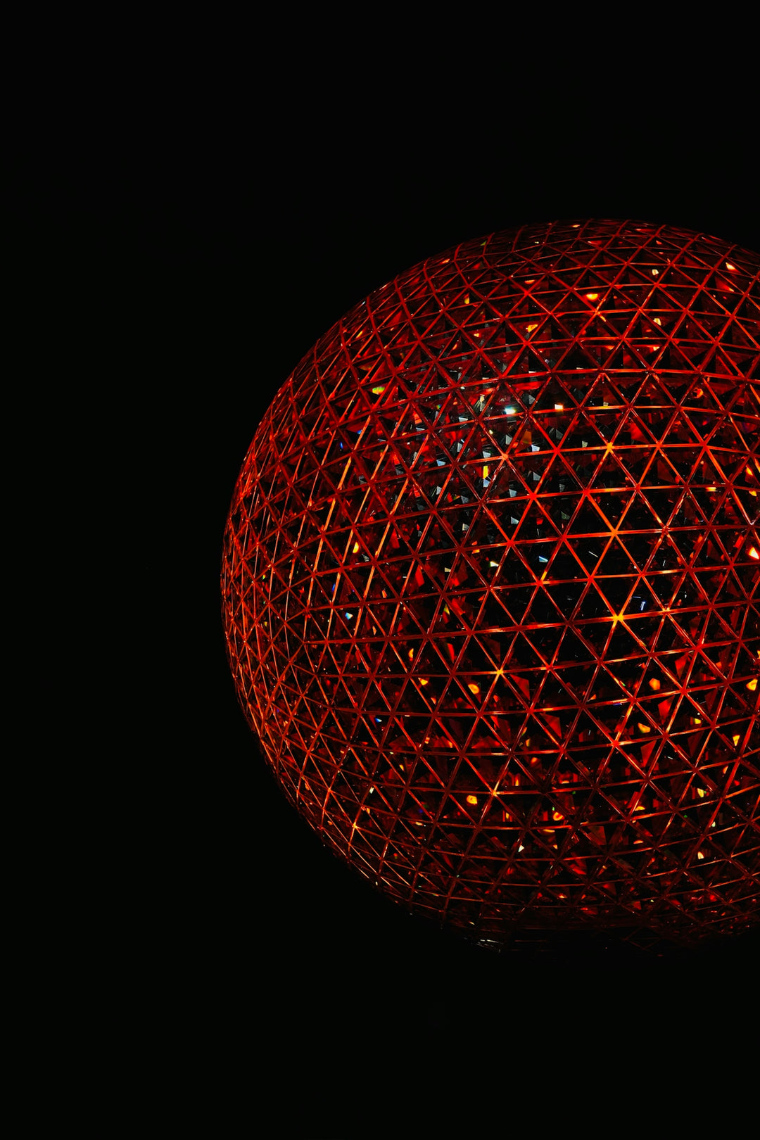 A glowing red geometric sphere on a black background.