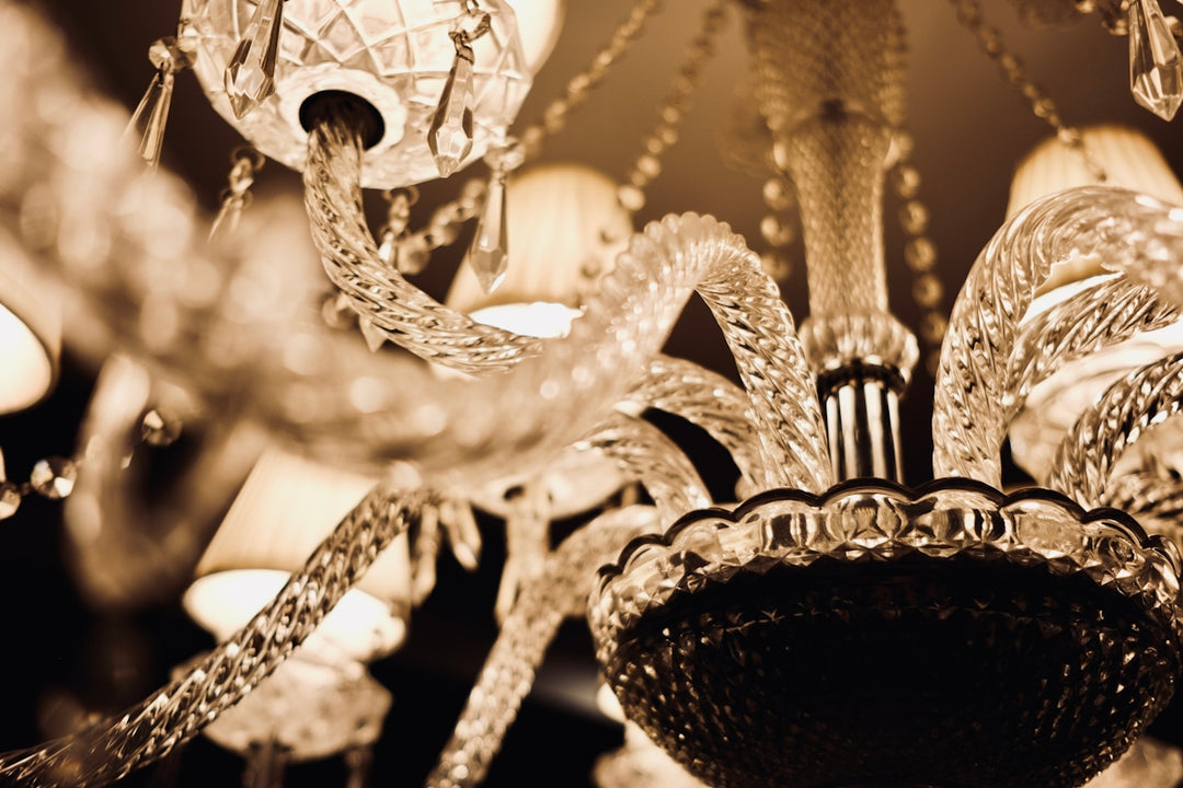 Close-up of an ornate crystal chandelier with lights.