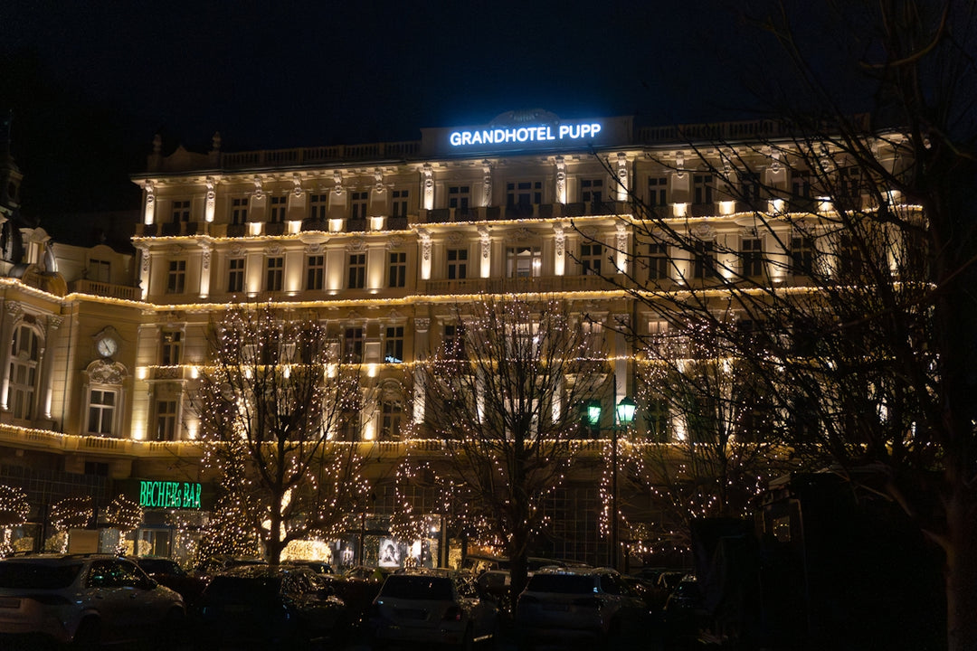 Grand hotel illuminated at night with decorative lights