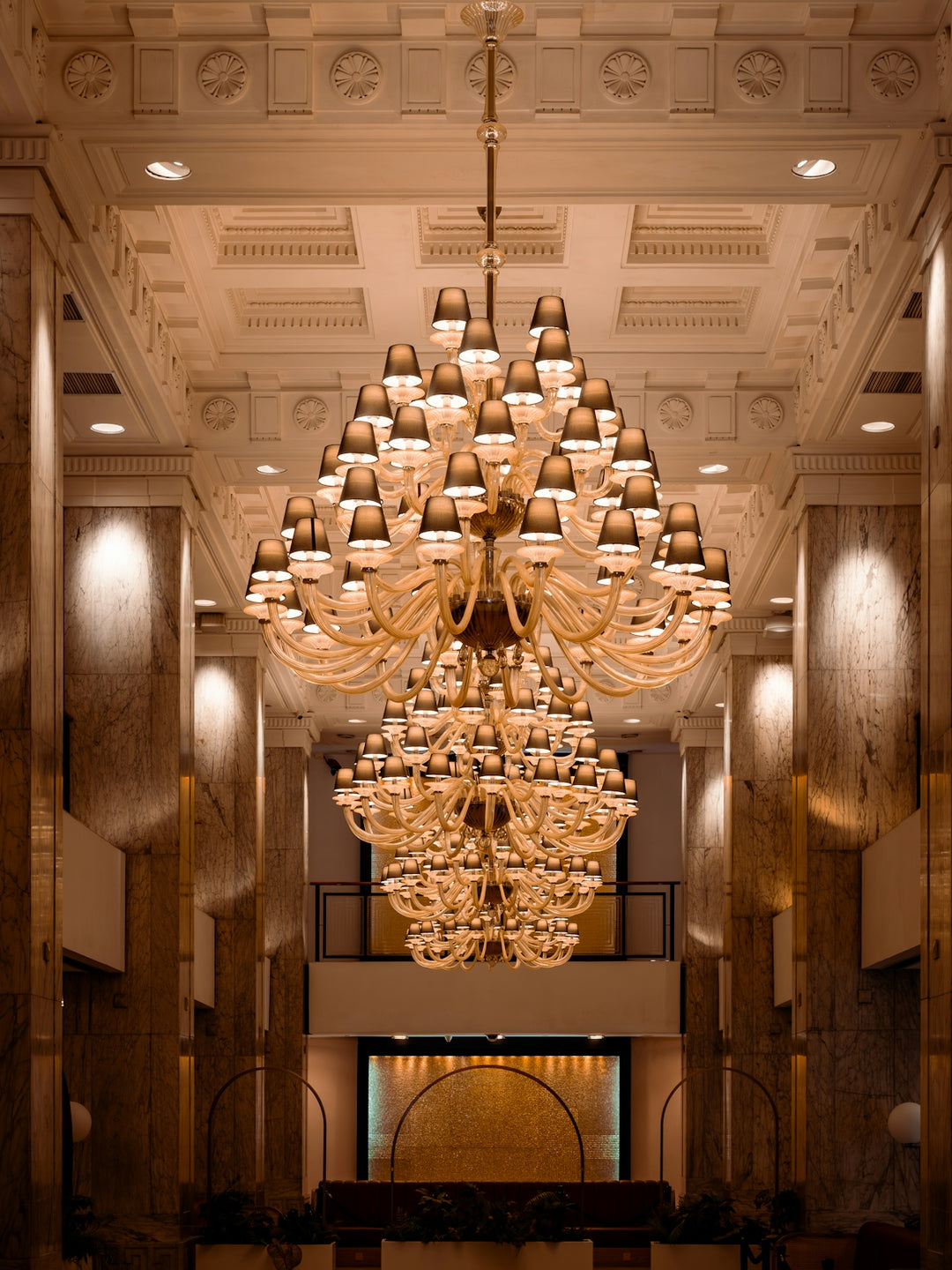 An ornate chandelier hangs in a grand hall.