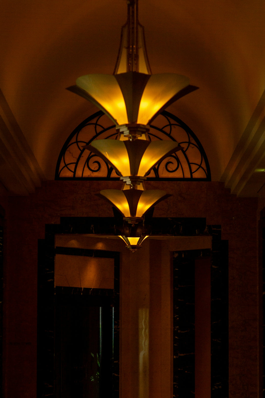 Art deco chandelier with warm glowing lights.